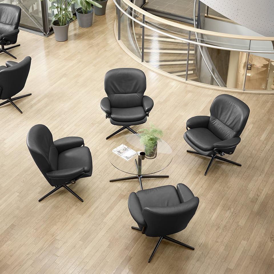 Four Stressless® Rome reliners around a table 